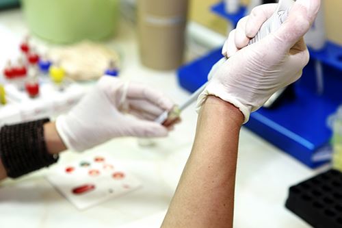 Lab Technician Performing Blood Testing